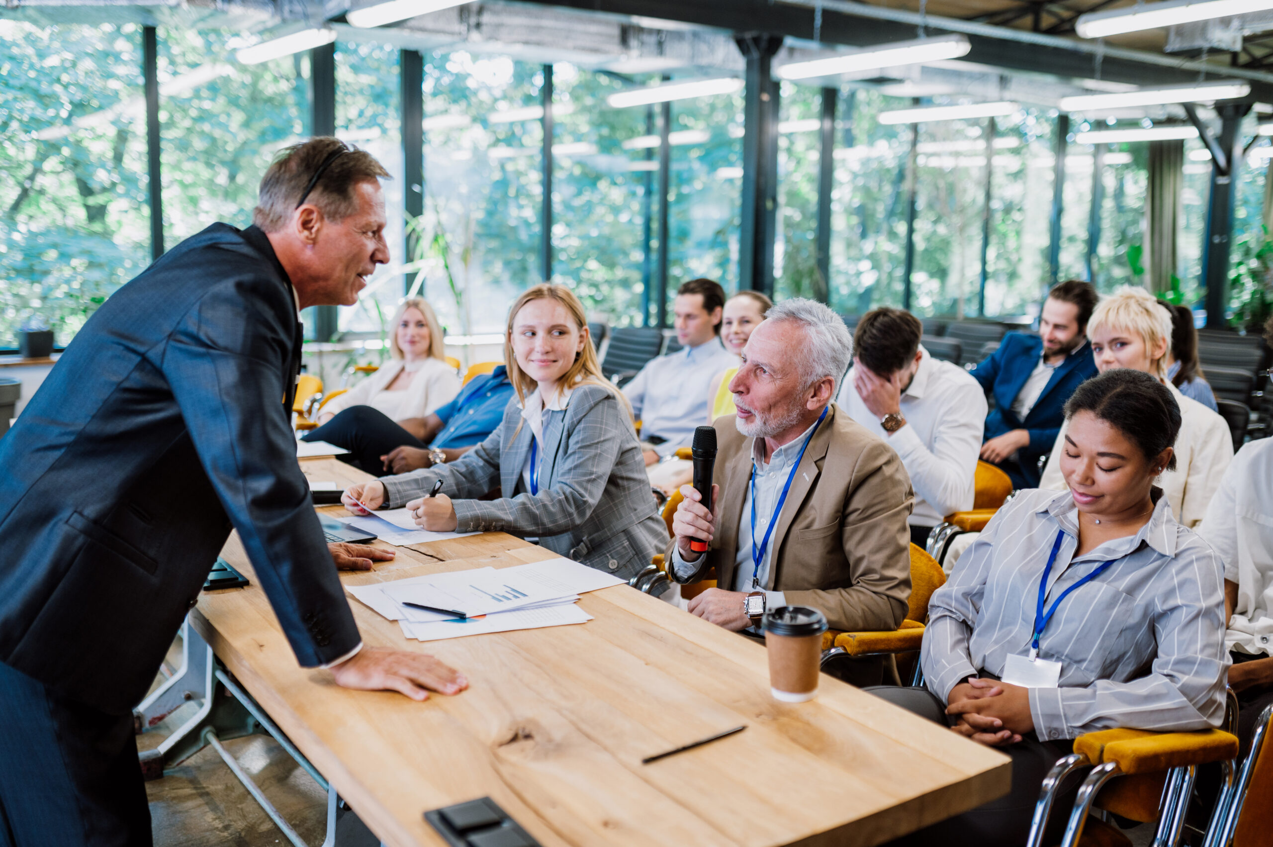 Cinematic image of a conference meeting. Business people sitting in a room listening to the motivator coach. Representation of a Self growth and improvement special event
